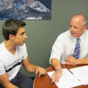 Attorney Bruce Sarbaugh consults a student