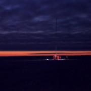 A panoramic image of the Arctic Sea ice and researchers at night