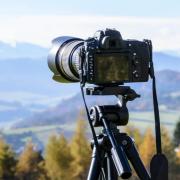 Camera on tripod overlooking mountains