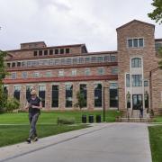 Student walks by Colorado Law building