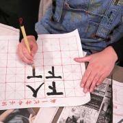 Student practices Chinese calligraphy 