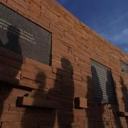 Visitors file by the inscribed plaques on the outer circle of the Columbine Memorial at Clement Park. Credit: Glenn Asakawa