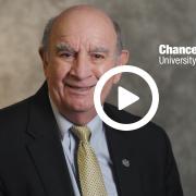 Chancellor Phil DiStefano with a video play button overlay