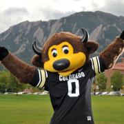 Celebratory Chip on campus with Flatirons in the background