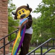 Chip holding an LGBTQ pride flag