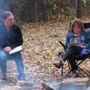 Professor Clint Carroll sits around fire with with the Cherokee Nation Medicine Keepers