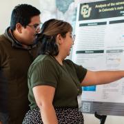 Jorge Santiago Ramírez and Kaitlyn Bishay examine a research poster at the 2023 Upper Colorado River Basin Water Forum