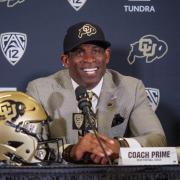 Deion Sanders (Coach Prime), smiles during a humorous moment during the press conference announcing his hiring as University of Colorado football teamÕs 28th head coach at the Touchdown Club at Folsom Field on December 4, 2022. (Photo by Glenn Asakawa/University of Colorado)