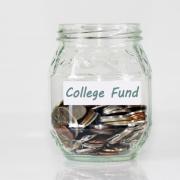 Stock image of a money jar labeled "College Fund"