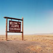 The 'welcome to colorful colorado' sign stands along a Colorado highway.