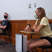 students physically distance and wear masks during class