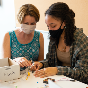 engineering workshop instructor works with a student