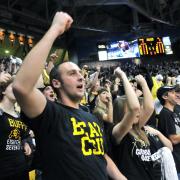 Buffs fans cheer at a men's basketball game CSU
