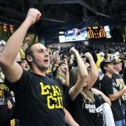 Fans cheer on the men's basketball team