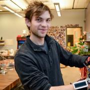Technology, Arts and Media student Kristof Klipfel poses with his "piano glove" 