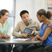 Colleagues look at tablet during training