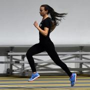 Dani Jones runs past empty bleachers