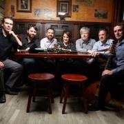 Irish folk ensemble Danu sitting in a pub