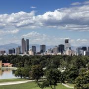 A photo of downtown Denver in front of the Rocky Mountains.