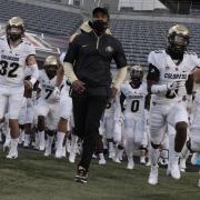 Karl Dorrell leading the Buffs onto the field against Arizona