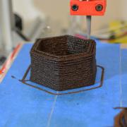 3D printing tip places layers of brown paste