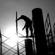 A person stands on scaffolding. 