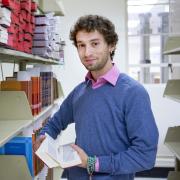 Graduate student Eben Yonnetti with Tibetan text