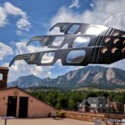 CU Boulder eclipse glasses with Flatirons in distance
