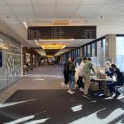 Campus community members gathering at a table in the engineering building lobby