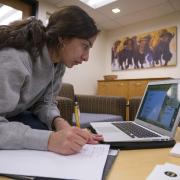 Student registers for classes on laptop