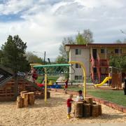 children play at new Kendall Apartments playground