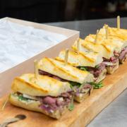 Sub sandwiches on a wood serving board