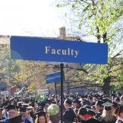 Faculty sign at commencement.