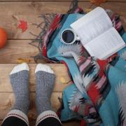 Stock image of someone sitting on steps with fall items around them