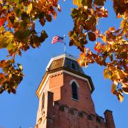 Orange fall leaves frame Old Main