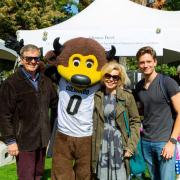 Student and family pose for a photo with Chip the buffalo mascot