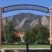 Farrand Field entrance with green field and Flatirons beyond