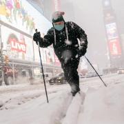 Person uses skis to traverse snowy New York City