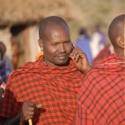 A Maasai person receives a call on his mobile phone. 