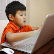 Child working on laptop computer