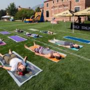 Students lying down in a yoga session outdoors