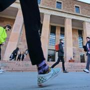 Students and campus community members walking outside of Norlin Library