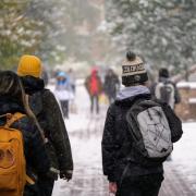 Campus community members walking on a snowy campus