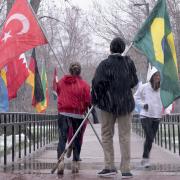 Students raise international flags on campus for Conference on World Affairs