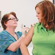 Nurse administering a flu shot vaccine