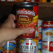 Woman reaches for canned good | Photo by Erin Kinney