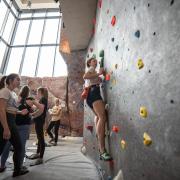 campus community members climbing the rock wall at the Rec