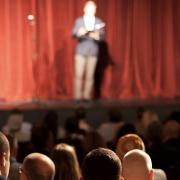 Stand up comedian on stage in front of an audience