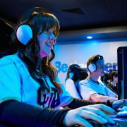 Students playing video games in the new lounge on campus