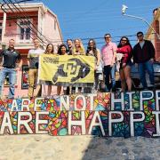 Students pose for photo in Chile with Buff flag